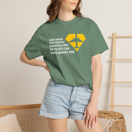 Person wearing a green t-shirt with a message design, standing against a neutral background.